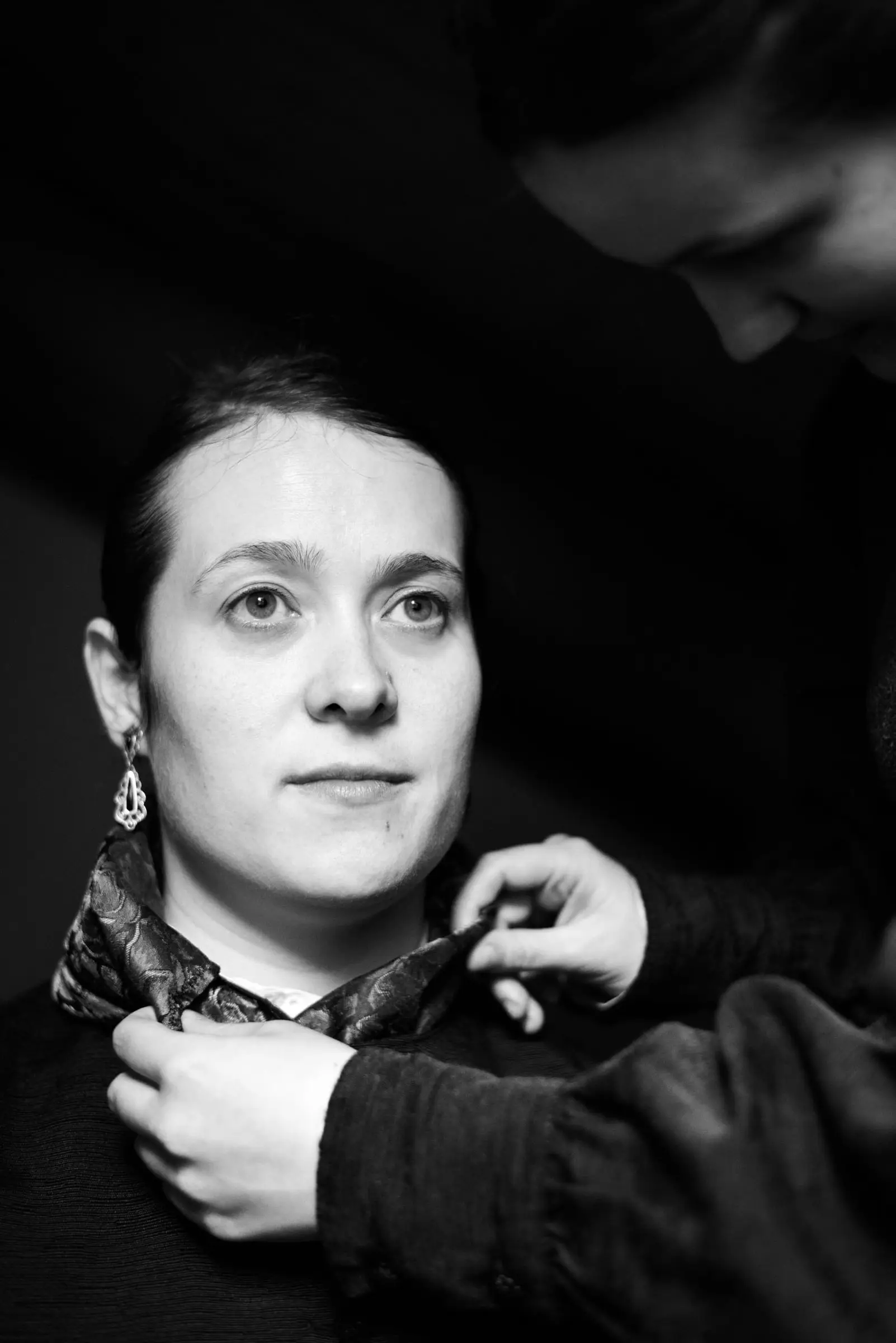 Retrato en branco e negro dunha Bouba mentres lle atan o pano ao pescozo